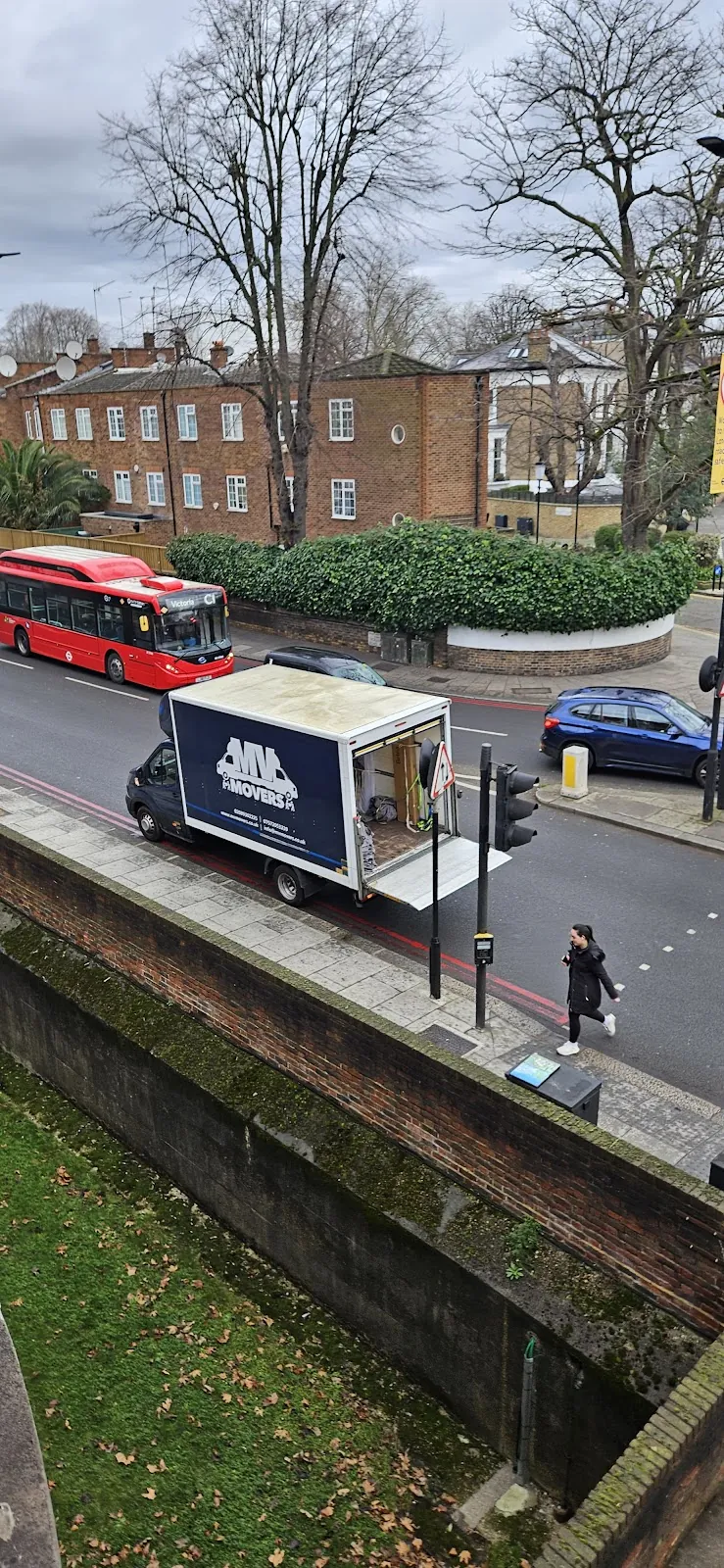 MV Movers removals van on a London street with a red bus MV Movers removals van on a London street with a red bus